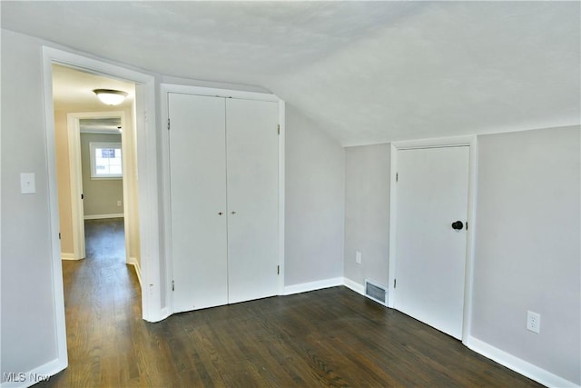 additional living space with lofted ceiling and dark wood-type flooring