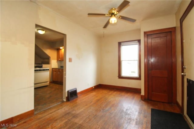 empty room featuring ceiling fan and dark hardwood / wood-style floors