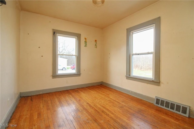 spare room with light wood-type flooring