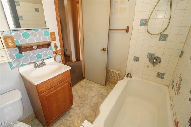 full bathroom with tiled shower / bath combo, vanity, and toilet