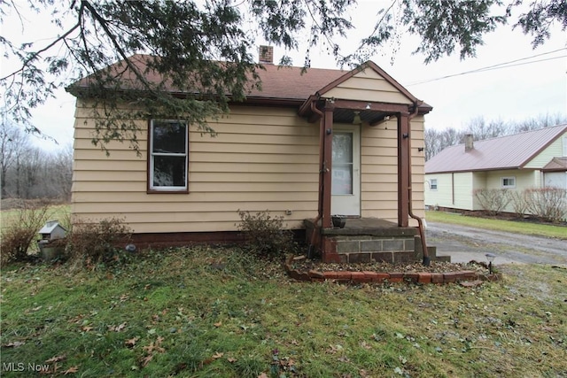 rear view of property with a yard