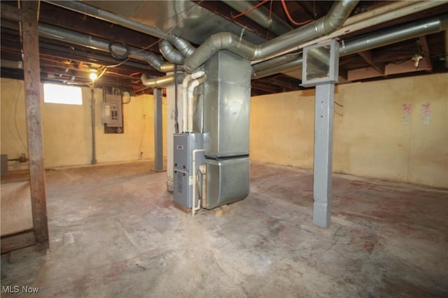 basement featuring heating unit and electric panel