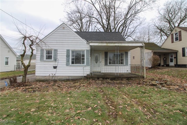 view of front of home featuring covered porch and a front yard