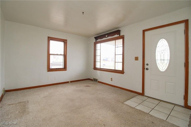 entrance foyer featuring light carpet