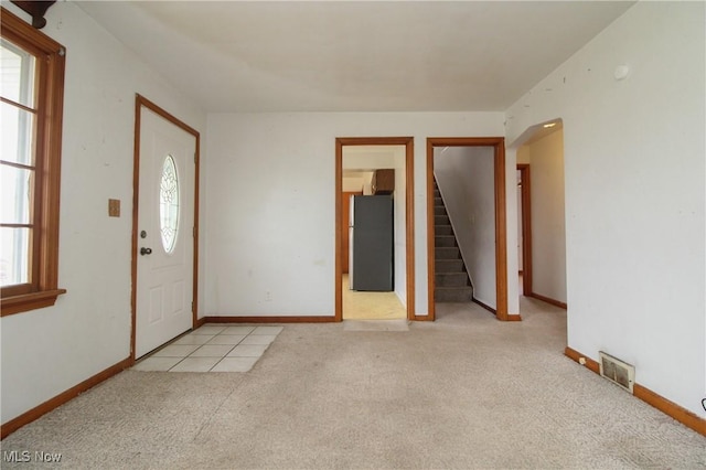 entryway featuring light colored carpet