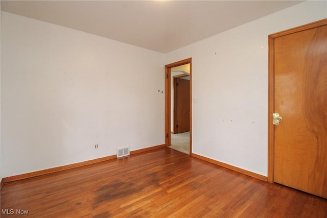 spare room with hardwood / wood-style floors