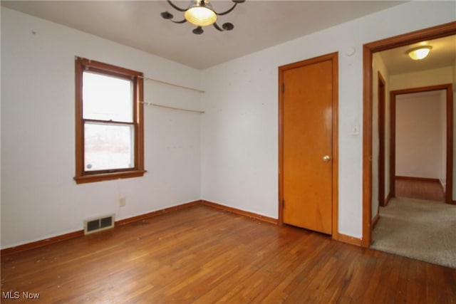 unfurnished bedroom with hardwood / wood-style flooring