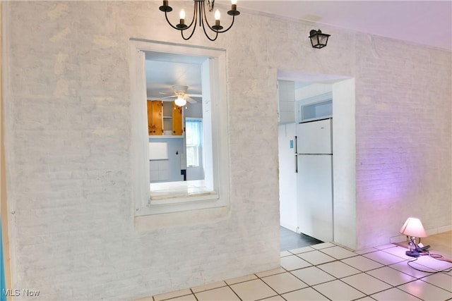 interior space featuring light tile patterned floors and a notable chandelier