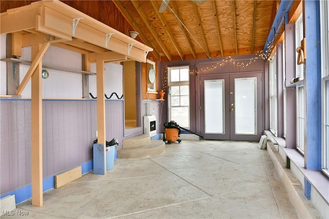 miscellaneous room featuring french doors and concrete floors