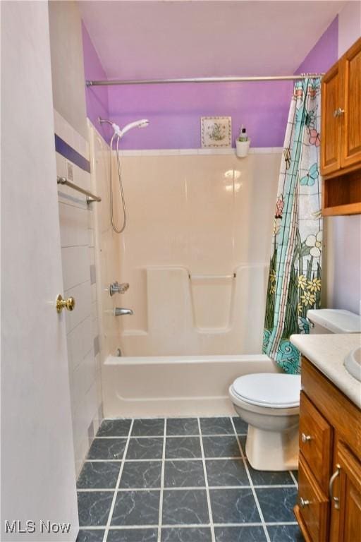 full bathroom with vanity, shower / bath combination with curtain, and toilet