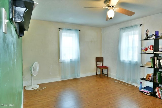 interior space featuring hardwood / wood-style flooring, ceiling fan, and plenty of natural light