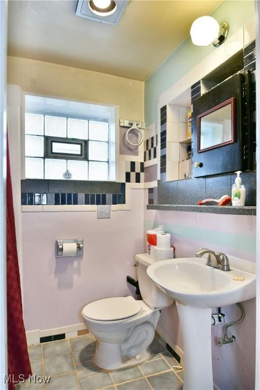 bathroom with tile patterned floors and toilet