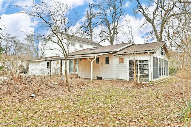 rear view of property with a sunroom