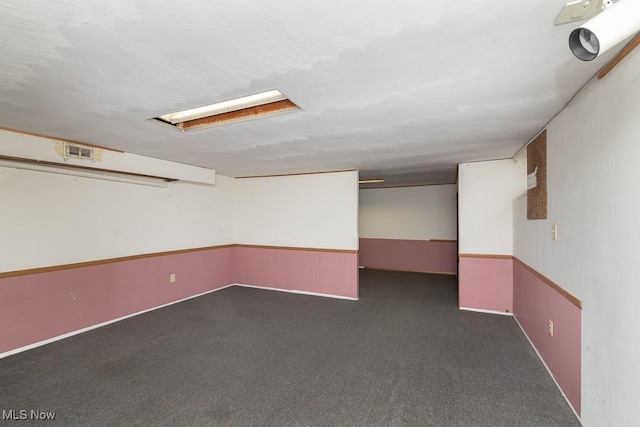 basement with dark carpet