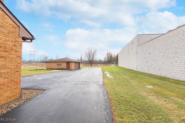 view of yard with a garage and an outdoor structure