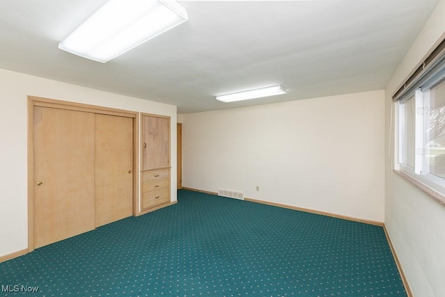 unfurnished bedroom with dark carpet