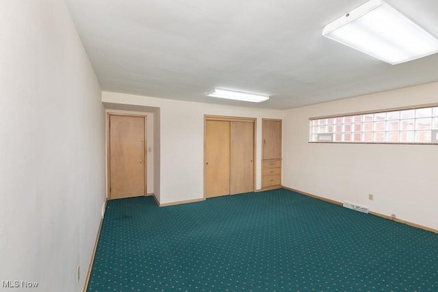 interior space featuring dark carpet