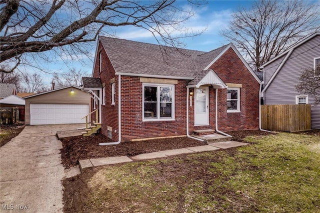 view of front of property featuring a garage, an outbuilding, and a front lawn