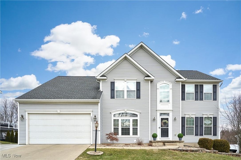 view of front of house with a garage and a front lawn