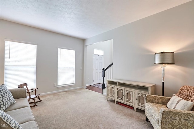 carpeted living room with a textured ceiling