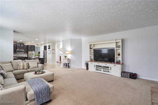 living room featuring light colored carpet and a textured ceiling