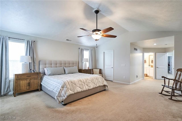 bedroom with multiple windows, vaulted ceiling, light carpet, and ceiling fan