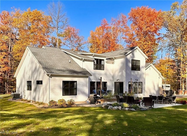 back of property featuring a lawn, central AC, and a patio area