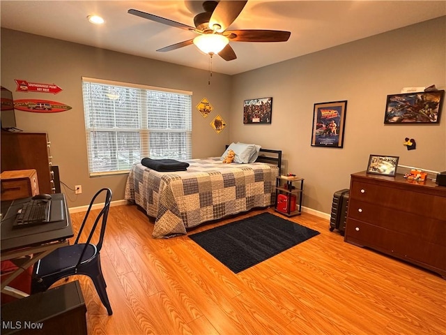 bedroom with ceiling fan and light hardwood / wood-style flooring