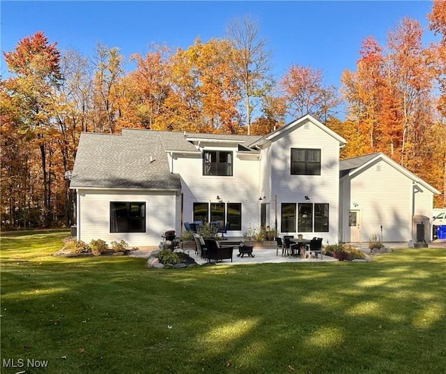 back of house featuring a patio and a lawn