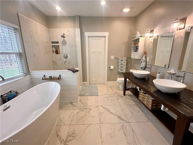 full bathroom with vanity, separate shower and tub, and toilet