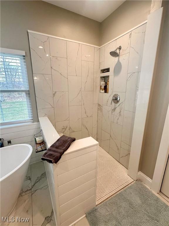 bathroom featuring independent shower and bath