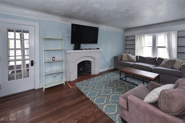 living room with dark hardwood / wood-style floors and a textured ceiling