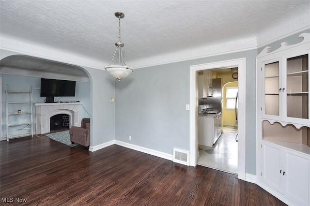 unfurnished living room featuring hardwood / wood-style floors and a textured ceiling