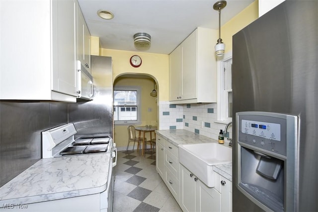 kitchen featuring white cabinetry, white appliances, and decorative light fixtures