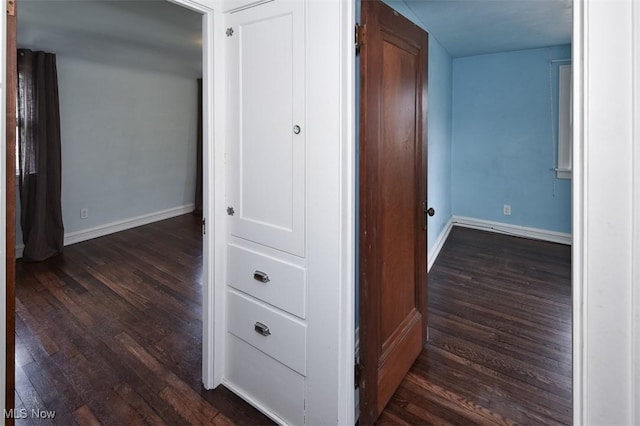 hall with dark hardwood / wood-style floors