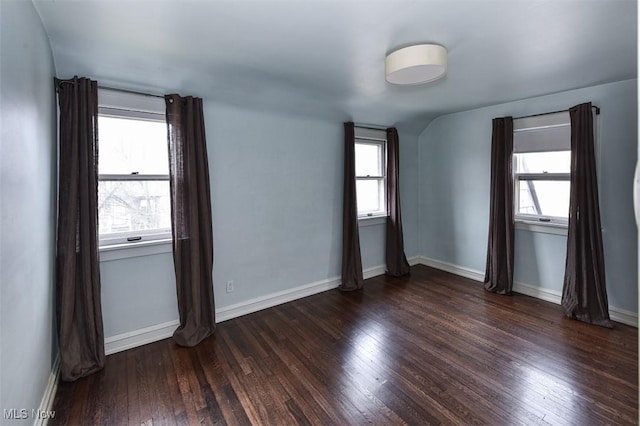 empty room with dark wood-type flooring