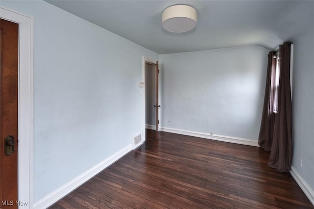 spare room with dark hardwood / wood-style flooring