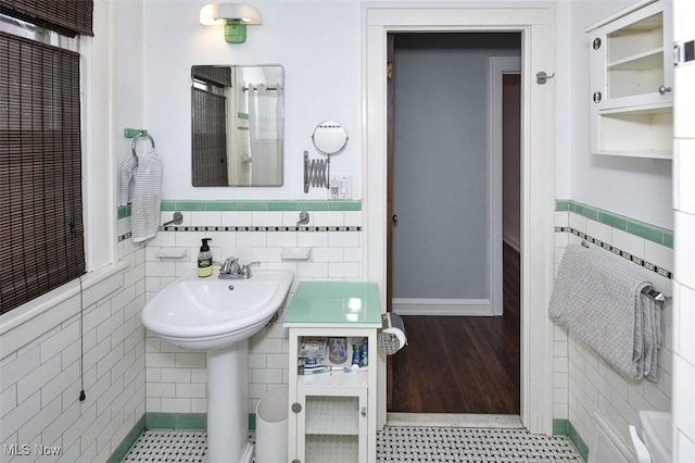 bathroom with tile walls and tile patterned floors