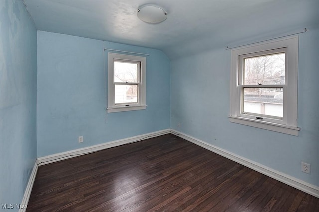 bonus room featuring dark hardwood / wood-style floors and vaulted ceiling