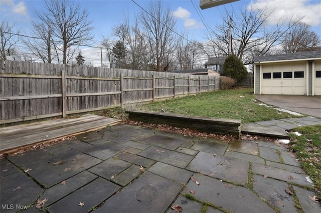 view of yard with an outbuilding, a garage, and a patio