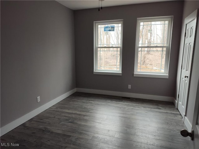 interior space with baseboards and dark wood finished floors