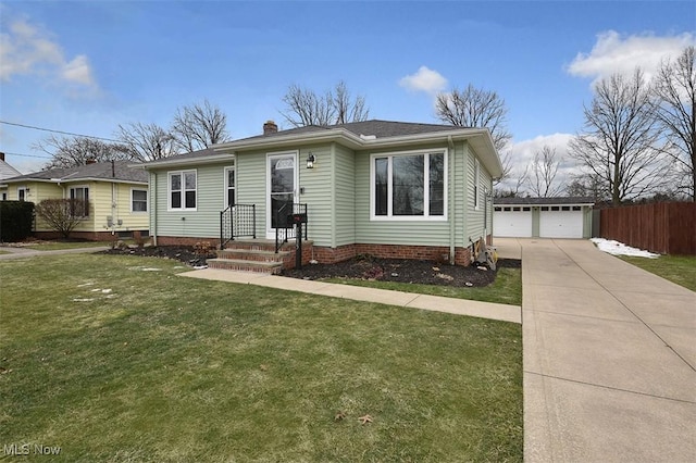 view of front facade featuring a garage, an outbuilding, and a front yard