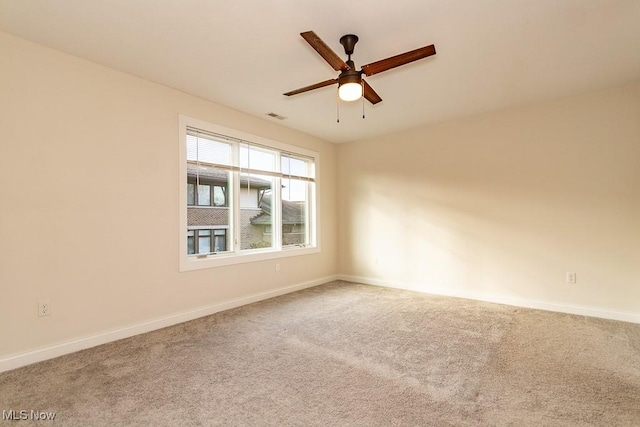 carpeted empty room featuring ceiling fan