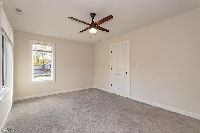 empty room with carpet floors and ceiling fan