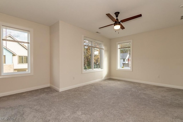 empty room featuring light colored carpet and ceiling fan