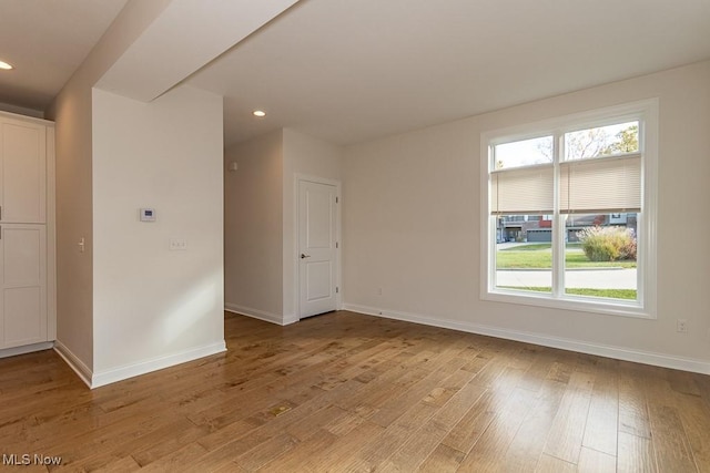 spare room featuring light wood-type flooring