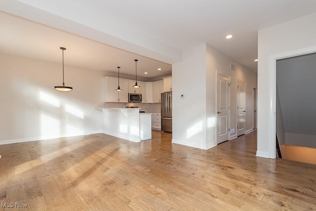 unfurnished living room featuring light hardwood / wood-style flooring