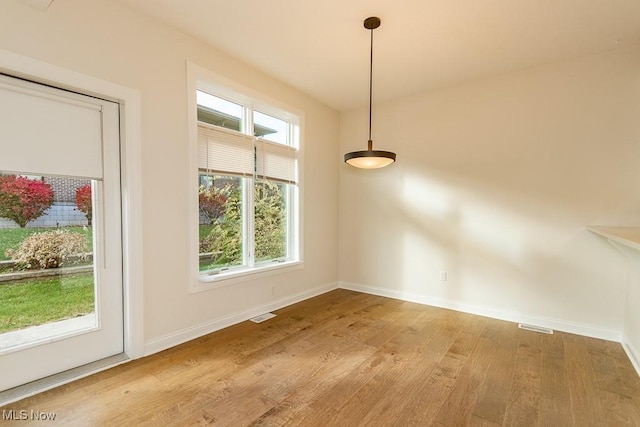 unfurnished dining area featuring light hardwood / wood-style floors