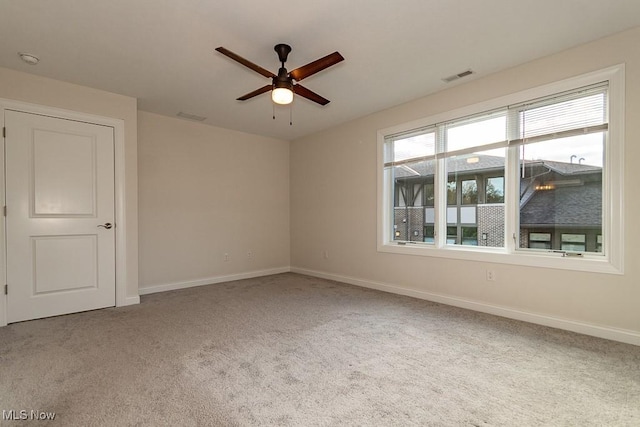 carpeted empty room featuring ceiling fan