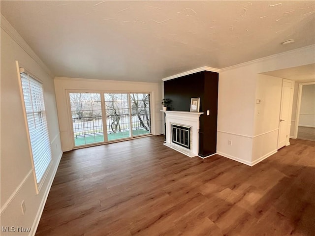 unfurnished living room with dark hardwood / wood-style flooring and crown molding